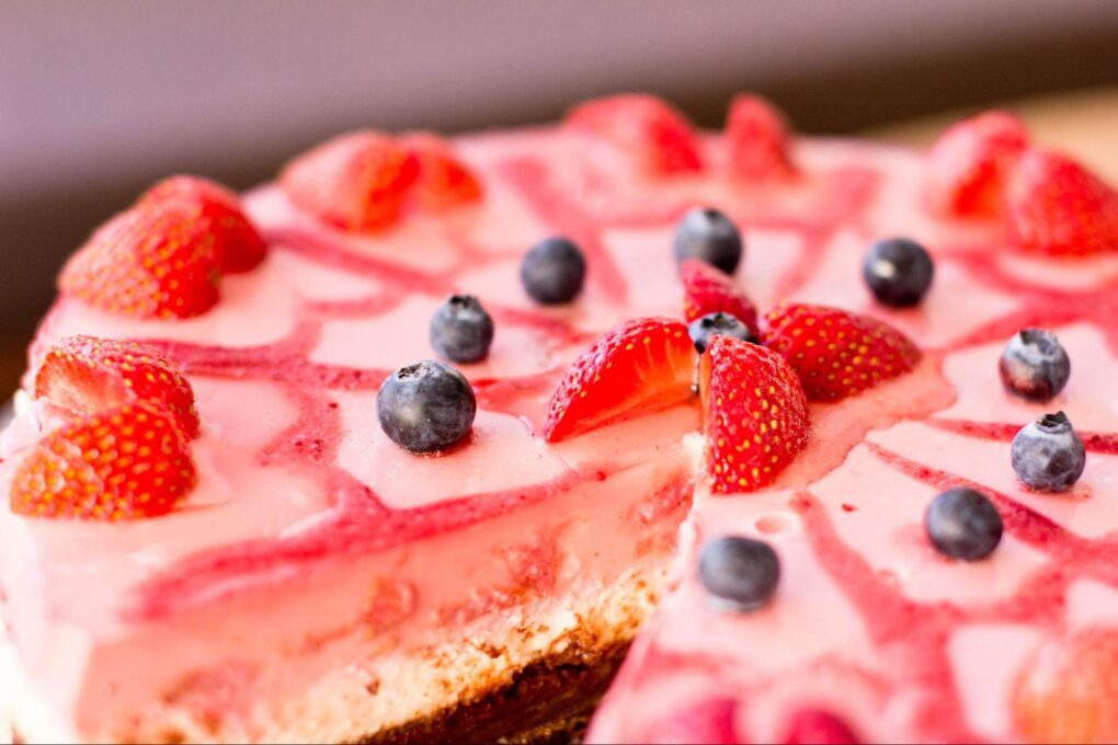 An ice cream cake with strawberries and blueberries