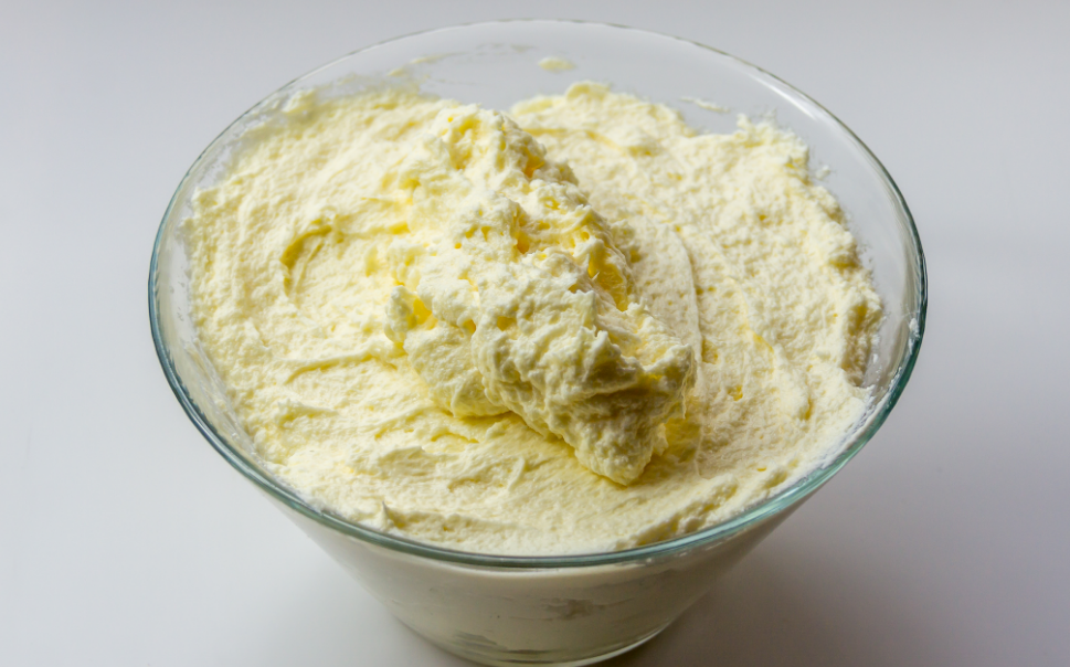 butter mixed with sugar and milk in a glass bowl