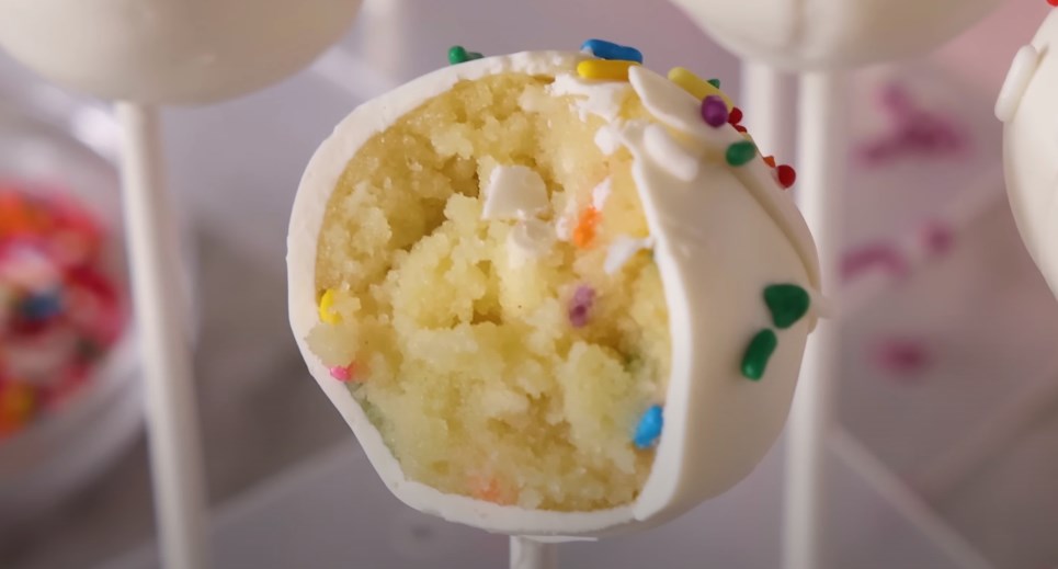 a white sprinkled cake pop in a cut